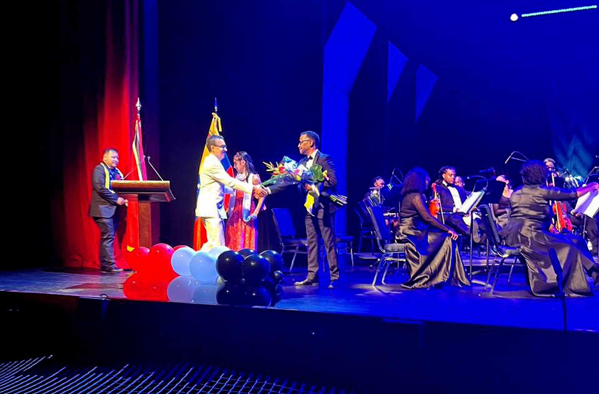 DR Henery recieving Flowers from Ambassador Cordero